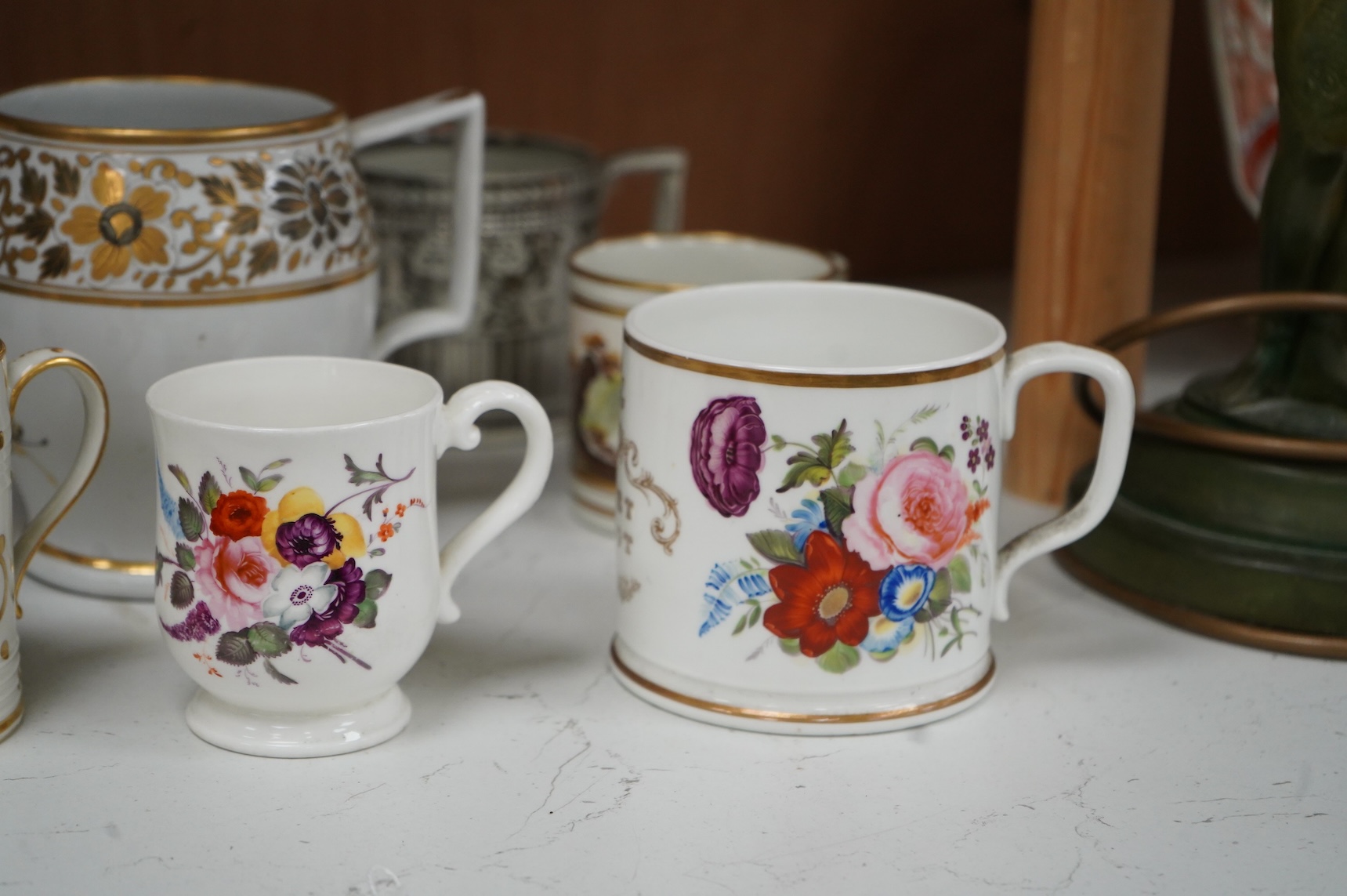 A pair of early 19th century English porcelain large mugs with gilt bands and five other early 19th century porcelain or pearlware mugs, one inscribed SG, Forget Me Not, largest each 14cm high